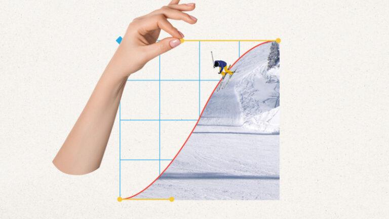 A person on a snowboard is being held up in a picture by a hand