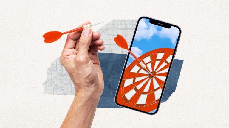 Hand throwing a dart at a board on a mobile device