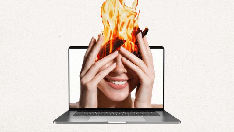 A woman holding her hands up to her face in front of a laptop