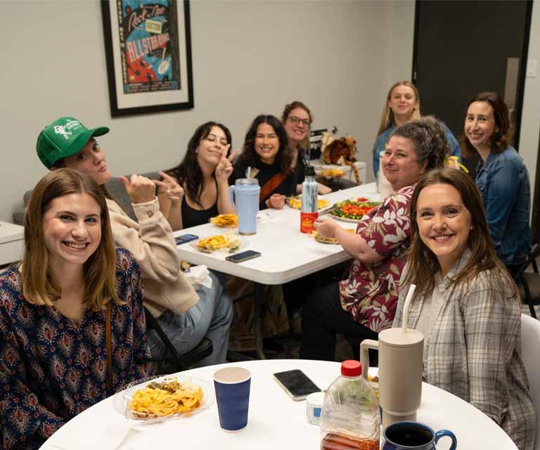 A group of people enjoying a meal together at a table